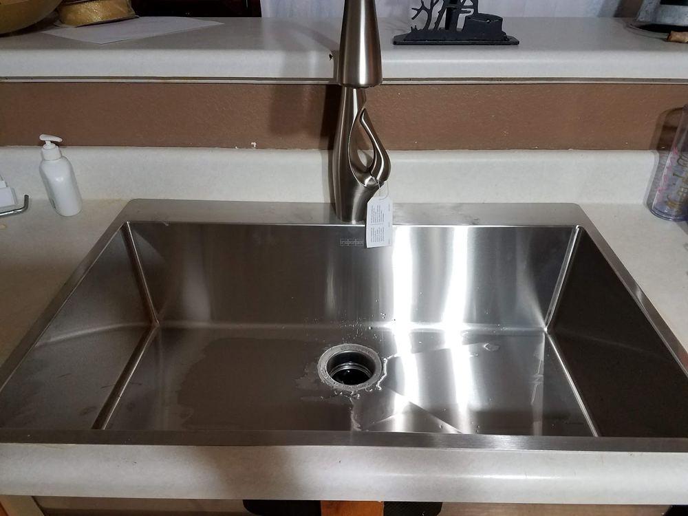 Stainless-steel sink and faucet installation completed by Trio Plumbing