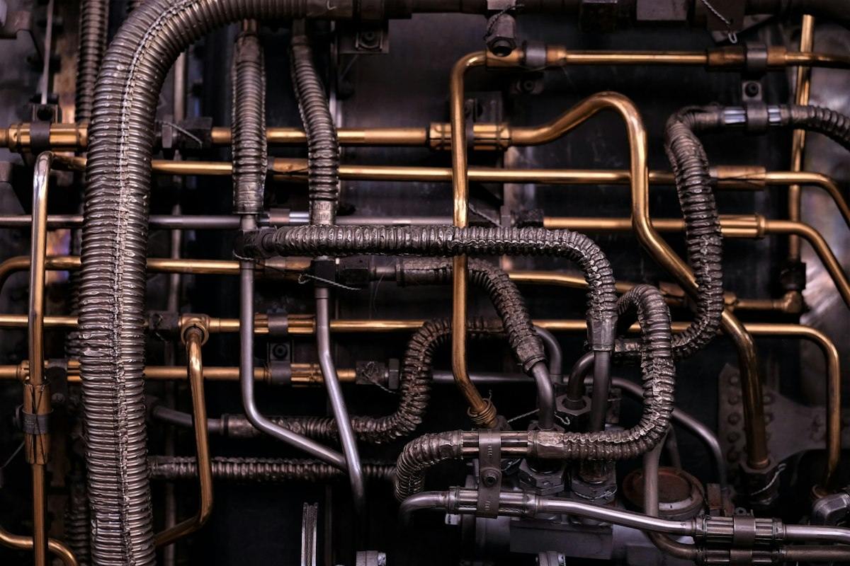 Rows of metal pipes running along a commercial building wall
